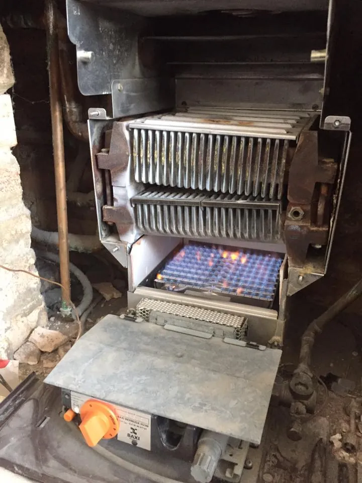Old back boiler opened up, burner lit during a service