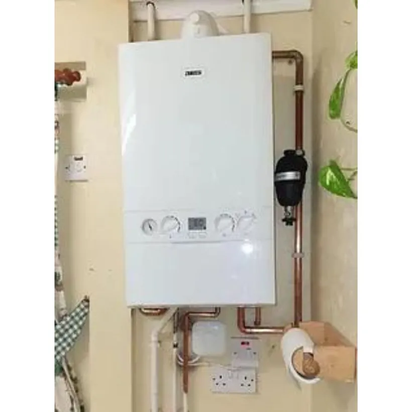 Combi boiler on a kitchen wall with a magnetic filter on the return